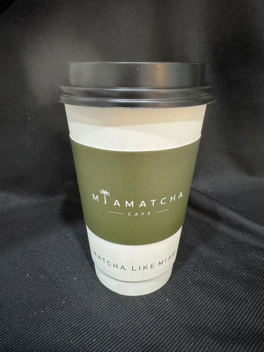 MiaMatcha cup with olive sleeve reading Matcha, like Miami