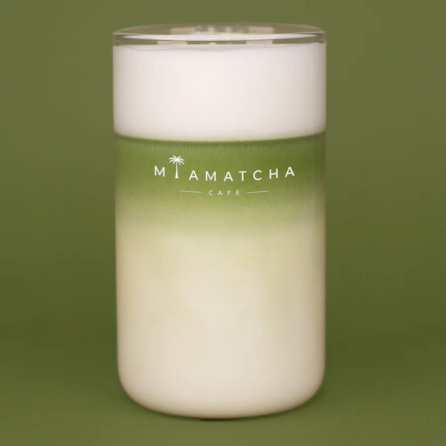 Hot matcha latte, milk foam settling over stone-ground matcha